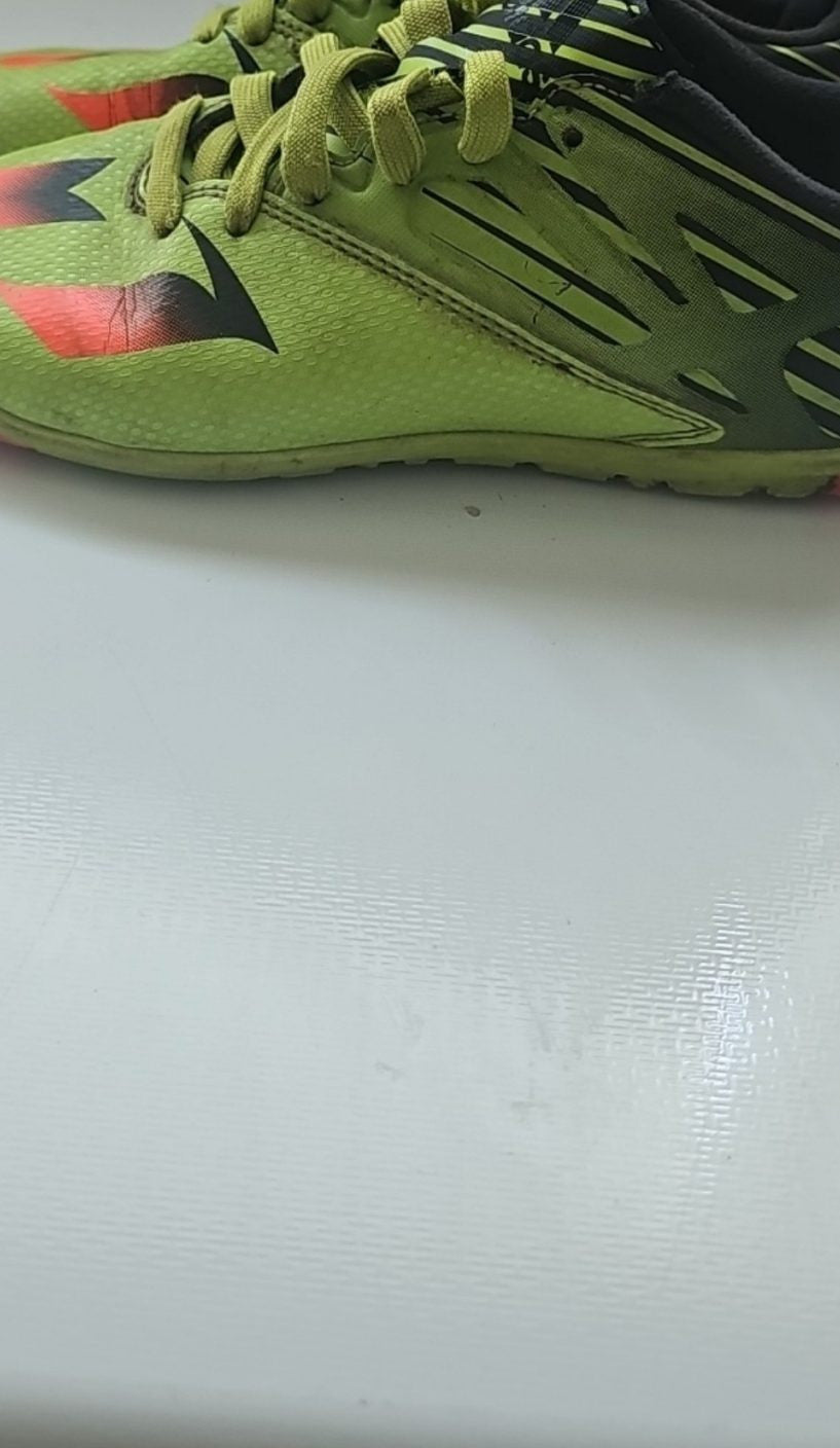 Adidas black and green soccer trainers with red accents, synthetic material, moderate wear.