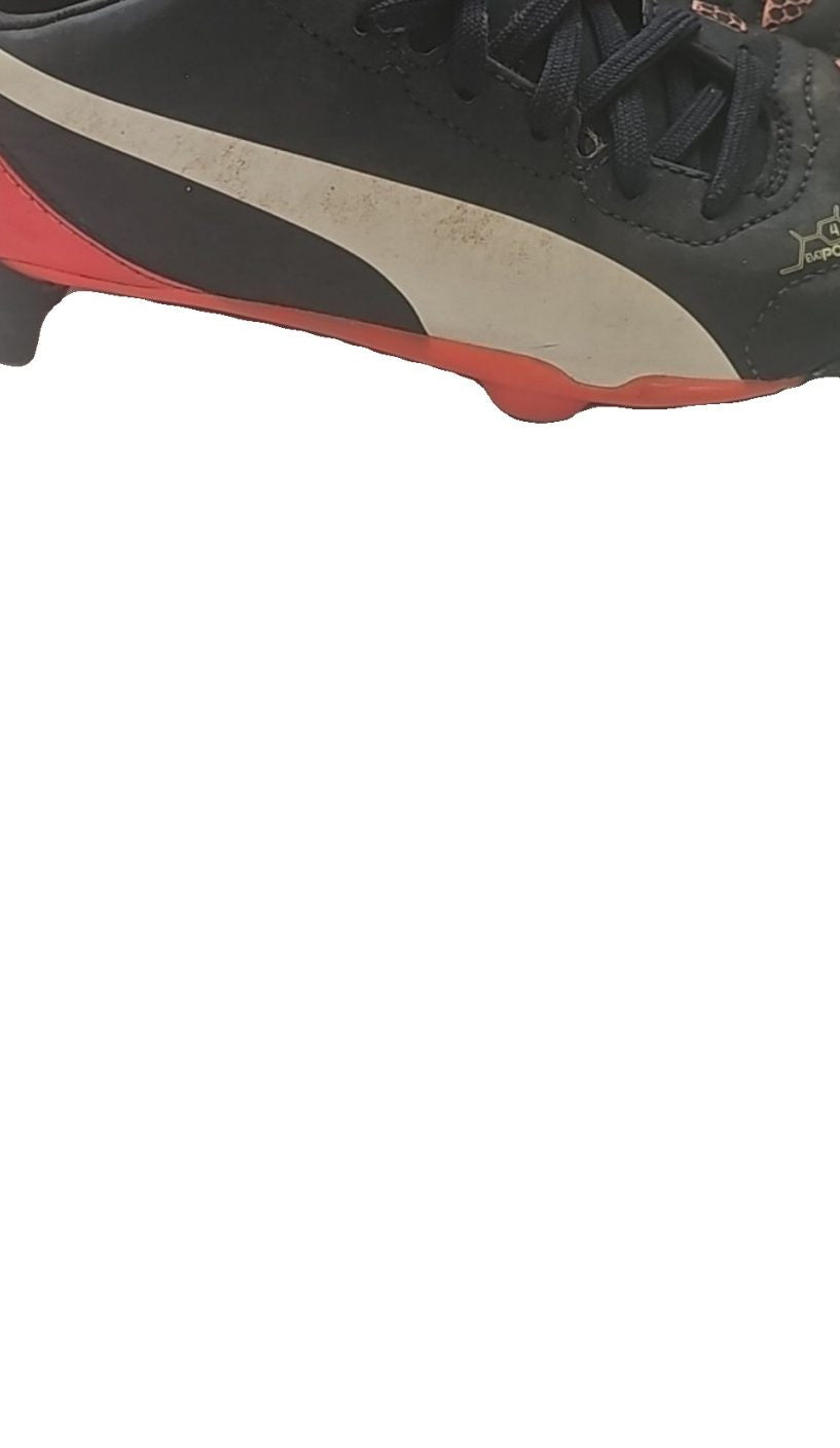 Puma black and red football boots with white formstripe, showing scuffing and wear.