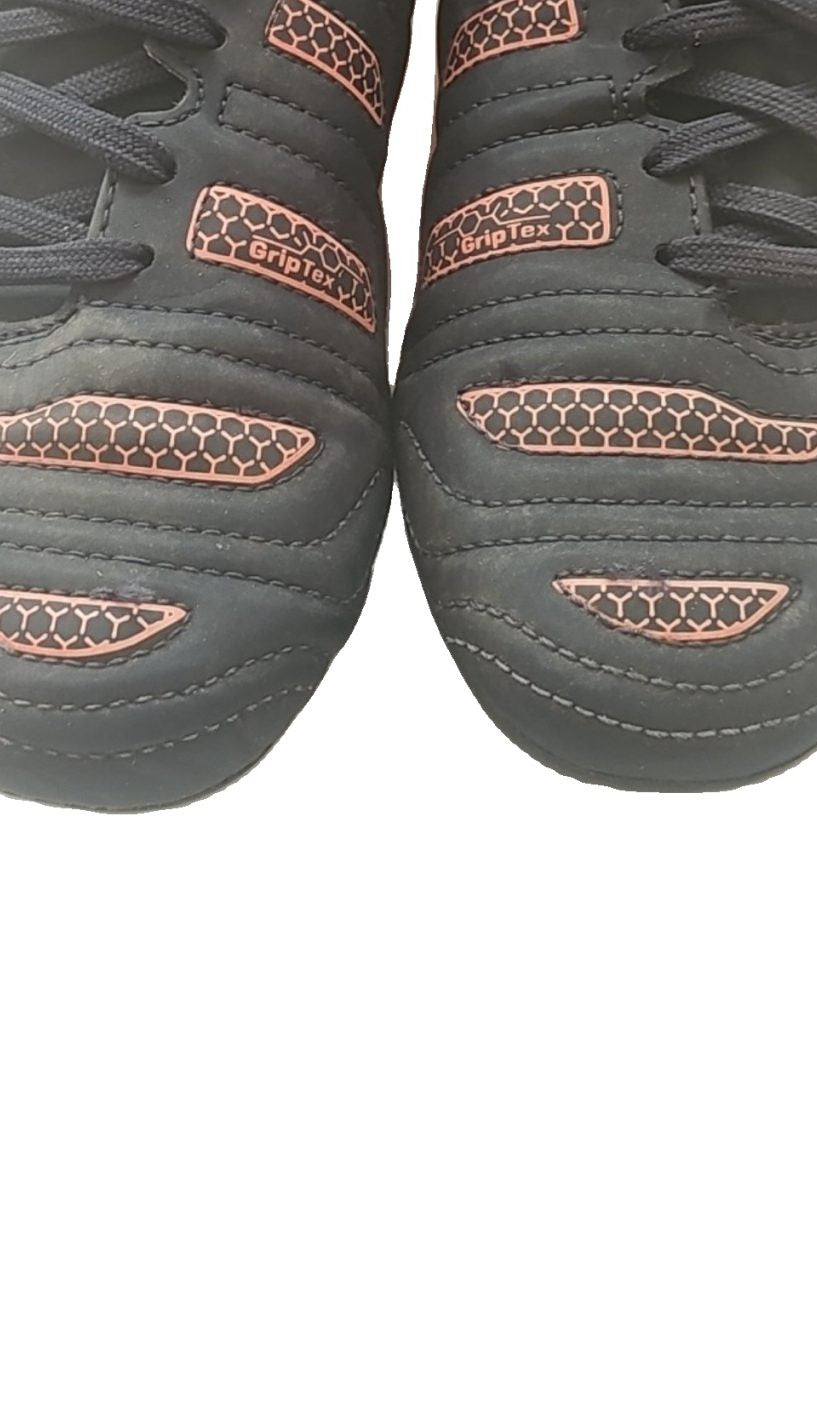 Puma black and red football boots with white formstripe, showing scuffing and wear.