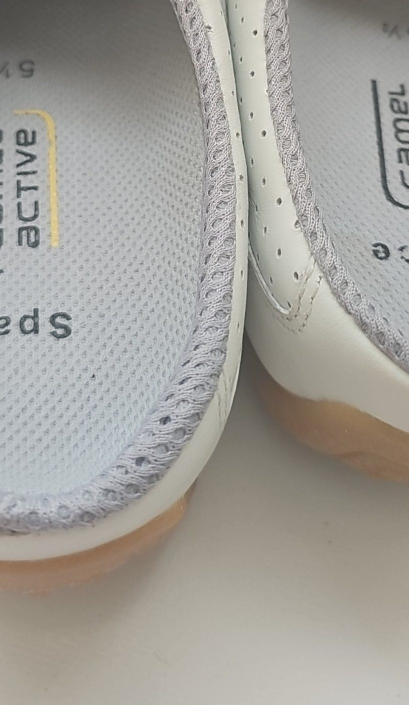 Camel Active grey and white slip-on shoes with perforated leather and logo details.