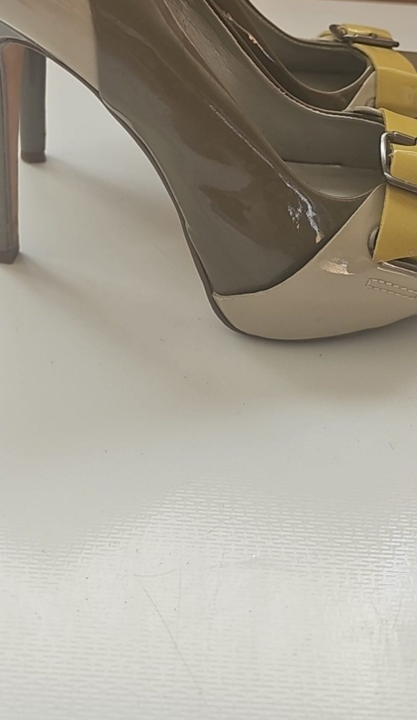 ALDO beige and taupe patent leather high heel shoes with yellow buckle detail.