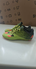 Adidas green and black soccer trainers with red accents, synthetic material, moderate wear.