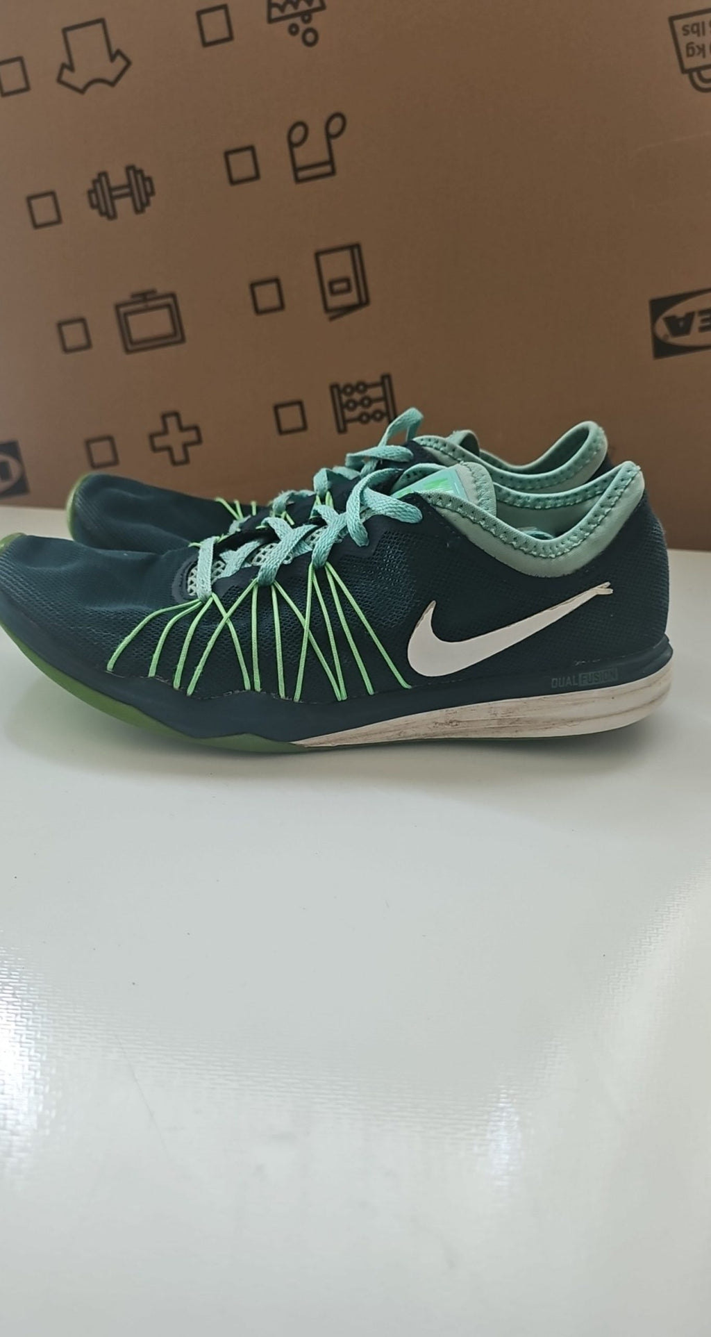 Nike black and green training shoes with mesh upper and dual fusion midsoles.