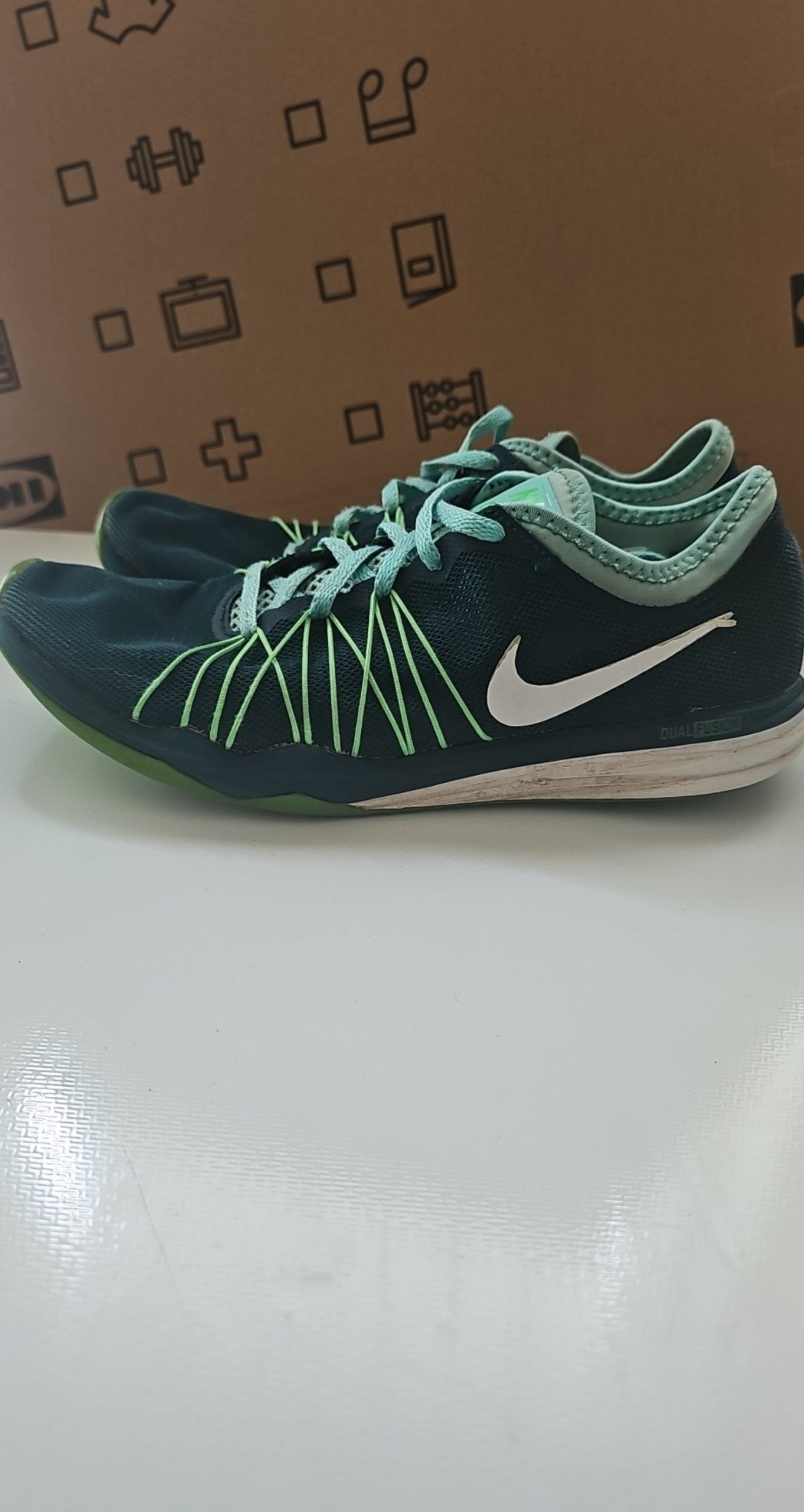 Nike black and green training shoes with mesh upper and dual fusion midsoles.