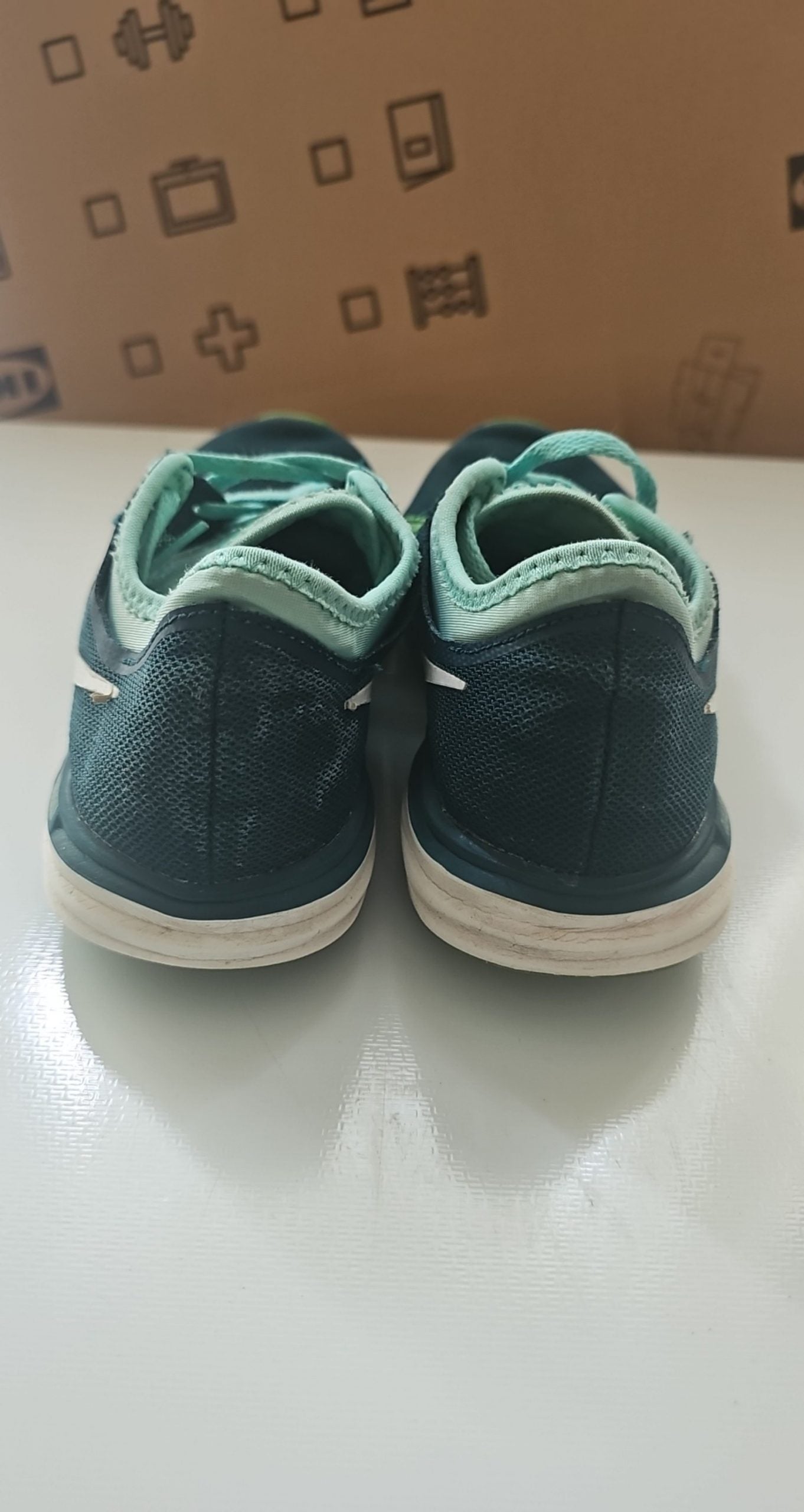 Nike black and green training shoes with mesh upper and dual fusion midsoles.