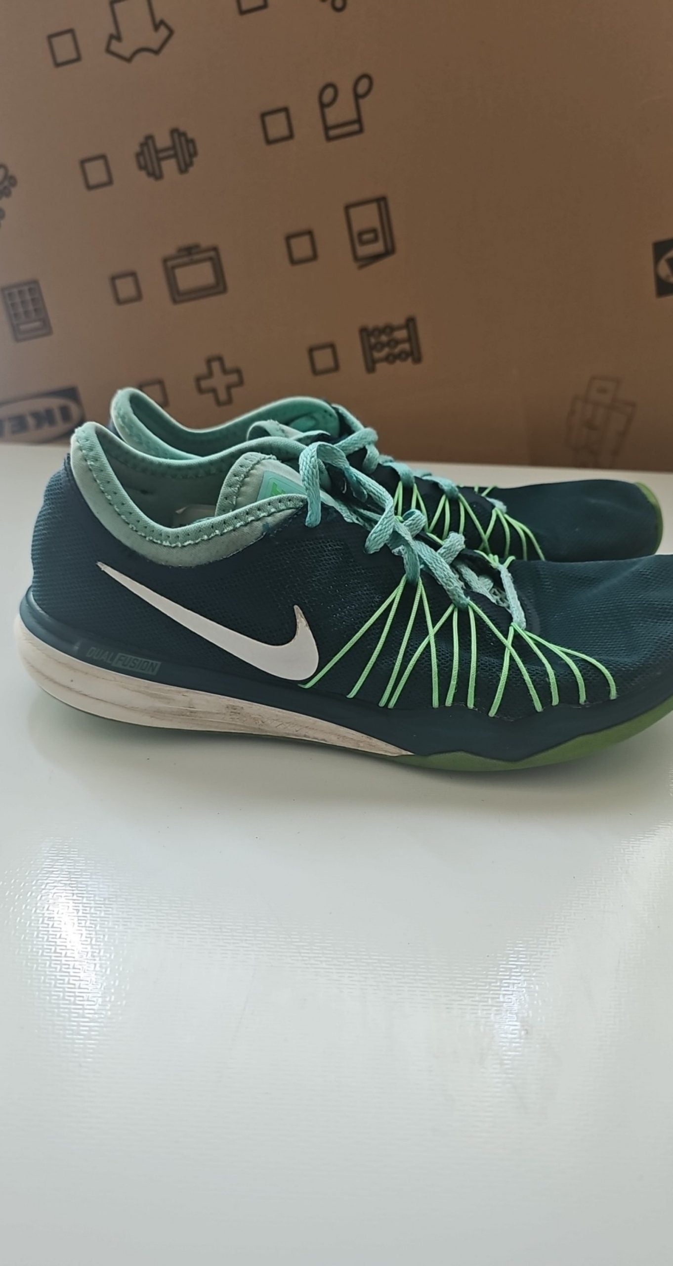 Nike black and green training shoes with mesh upper and dual fusion midsoles.