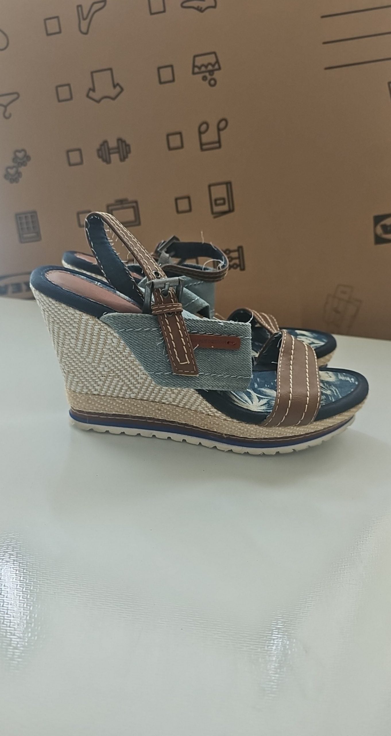 Escape beige and brown wedge sandals with green fabric strap and tropical print inner sole.