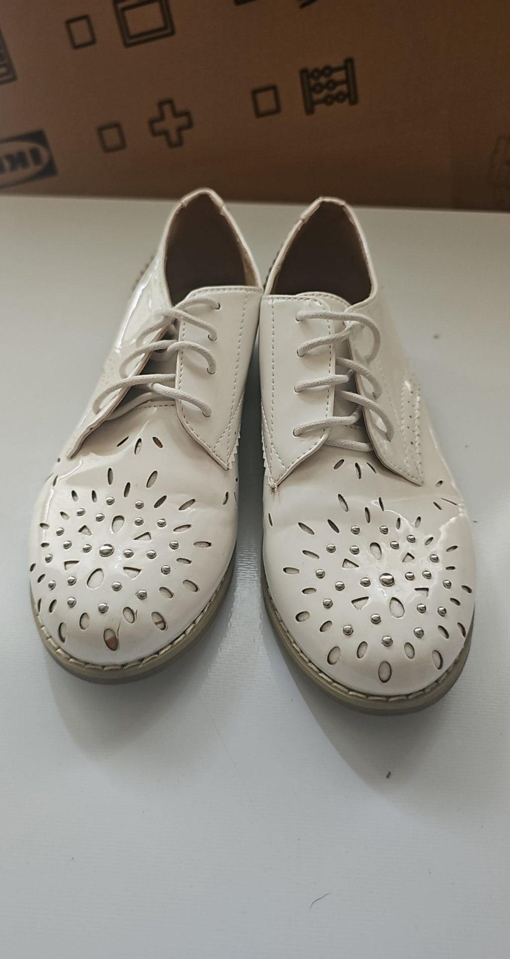 River Island beige brogues lace-up with cut-out design and metal stud detailing.