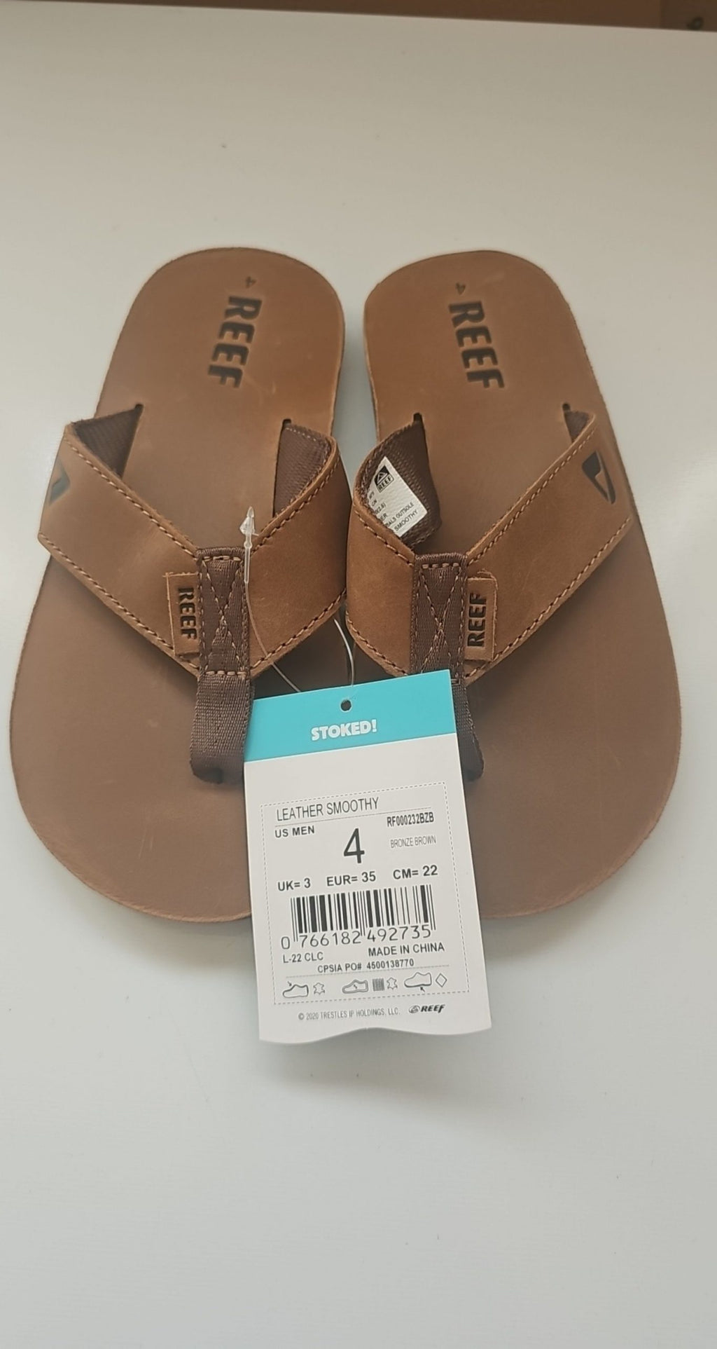 Reef brown leather Smoothy flip flops with sturdy thong straps and comfortable footbed.