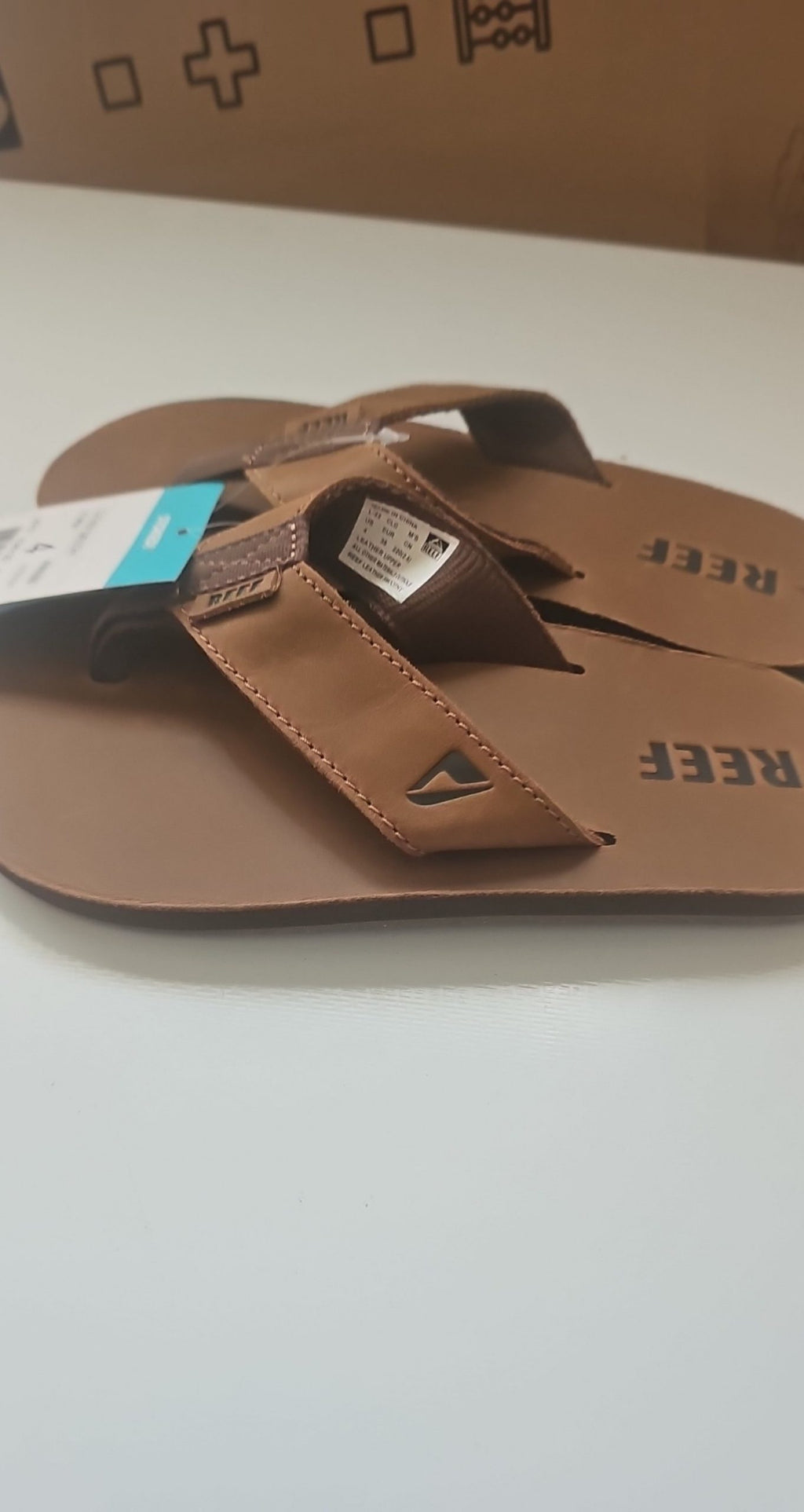Reef brown leather Smoothy flip flops with sturdy thong straps and comfortable footbed.