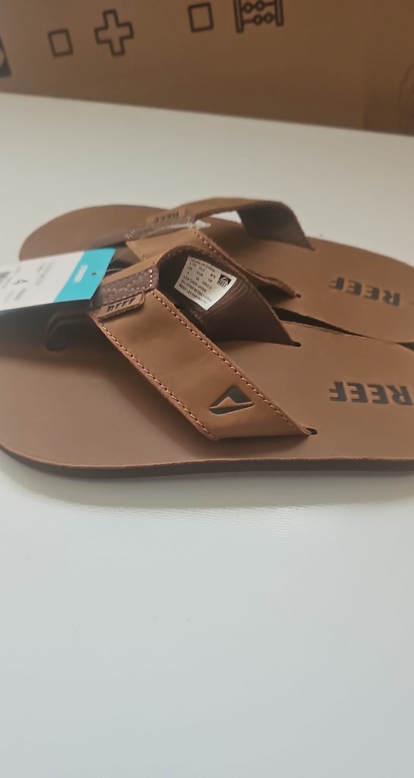 Reef brown leather Smoothy flip flops with sturdy thong straps and comfortable footbed.