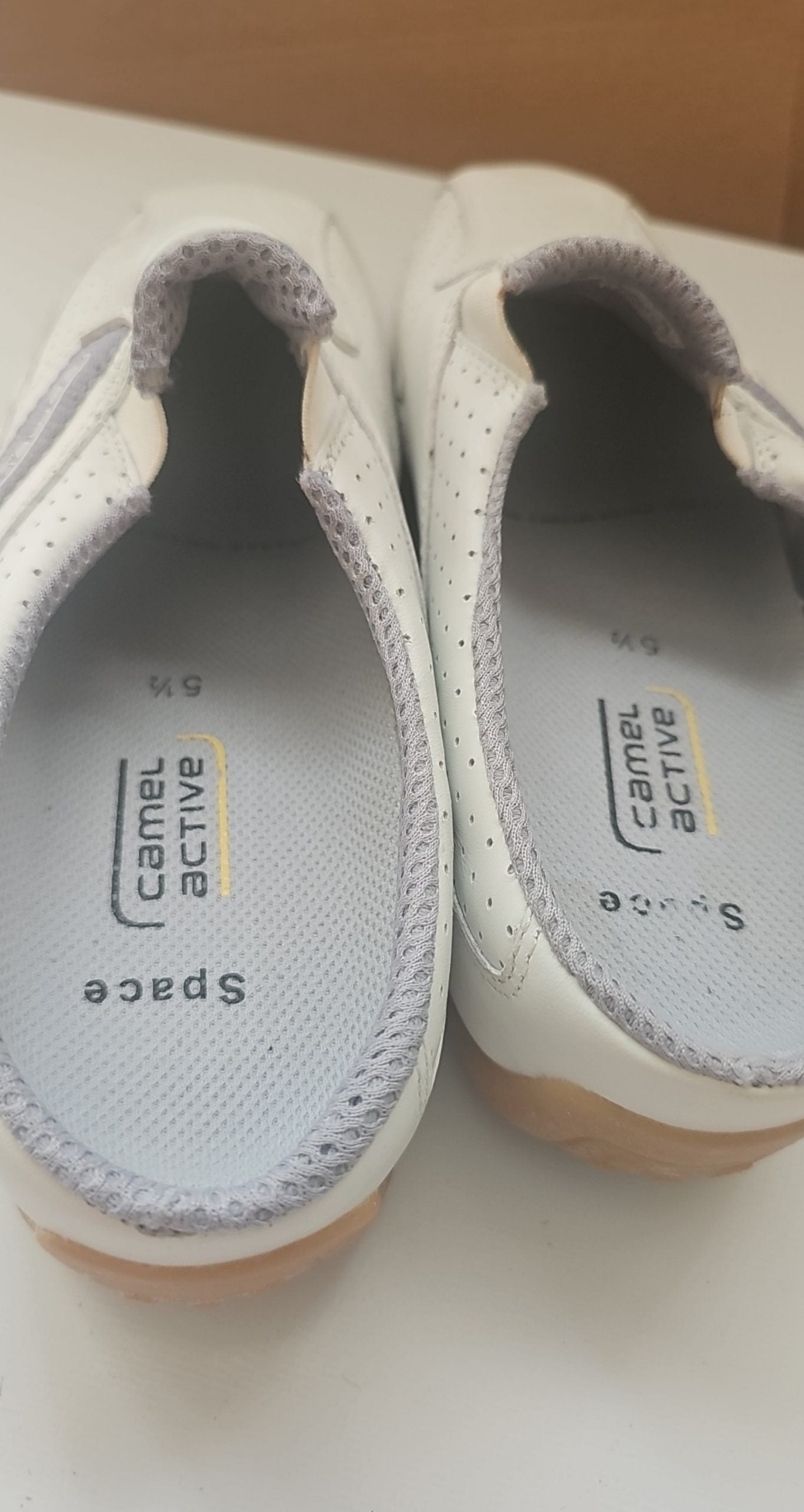 Camel Active grey and white leather slip-on shoes with perforated details and logo.