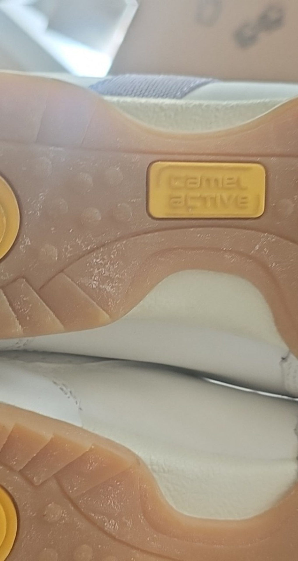 Camel Active grey and white leather slip-on shoes with perforated details and logo.