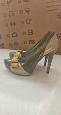 ALDO beige and taupe patent leather high heel shoes with yellow buckle detail.
