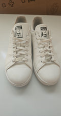 Adidas white Stan Smith sneakers with perforated three stripes and logo on tongue.