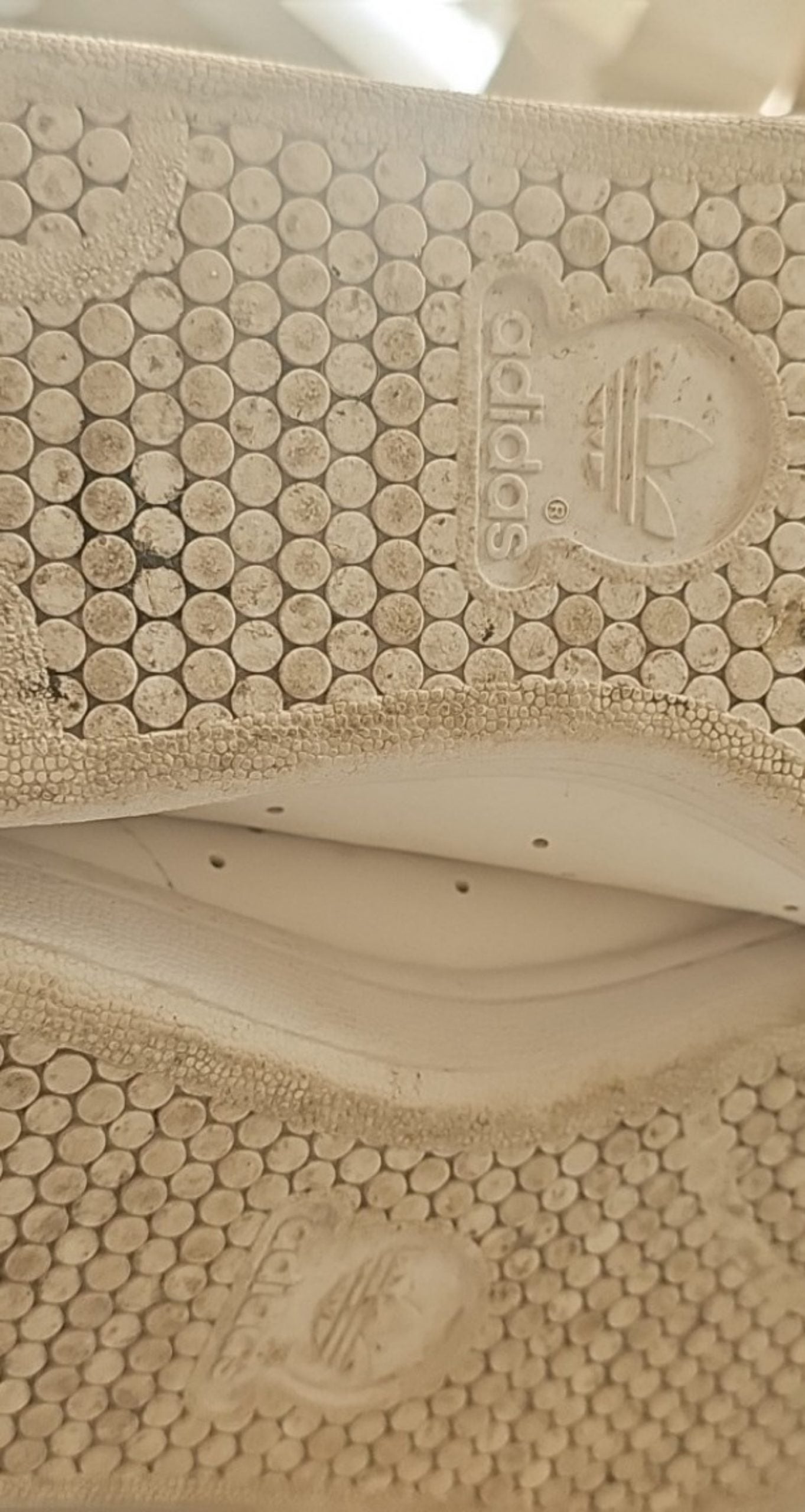 Adidas white Stan Smith sneakers with perforated three stripes and logo on tongue.