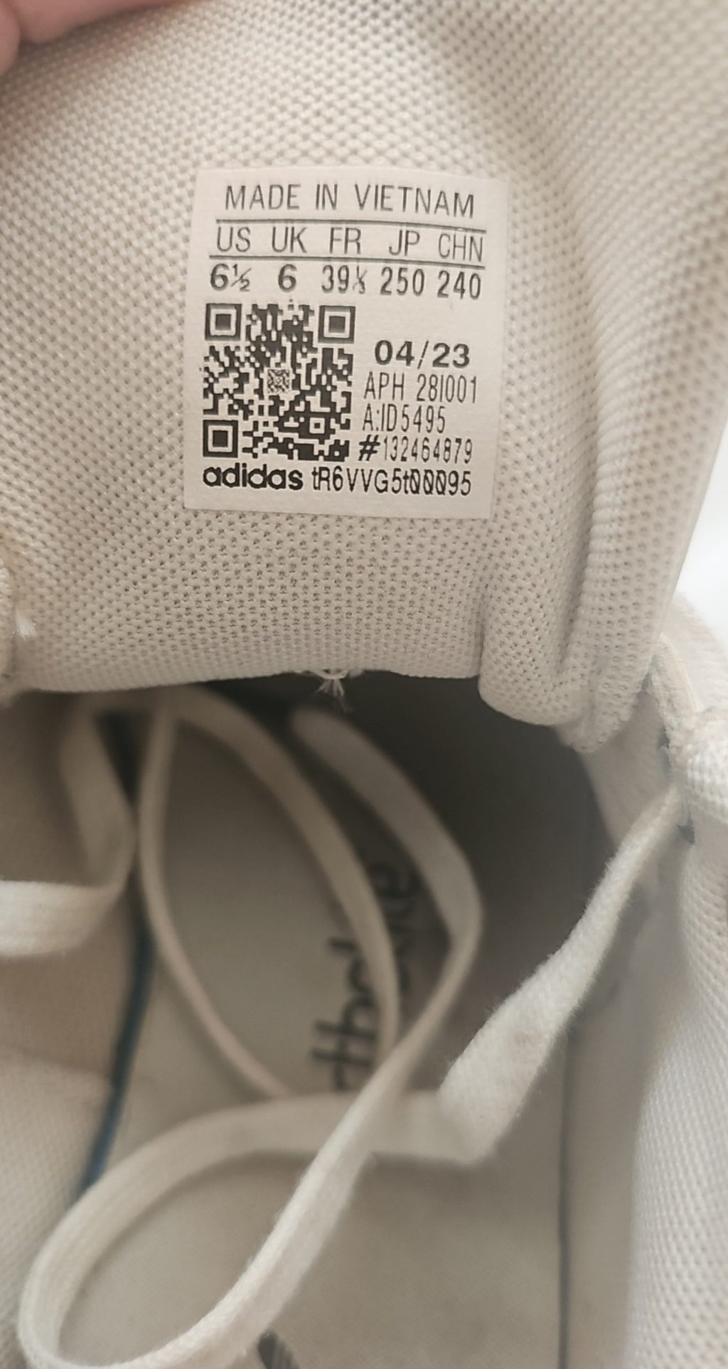 Adidas white Stan Smith sneakers with perforated three stripes and logo on tongue.